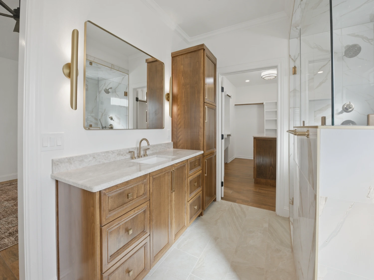 Bathroom remodeling project featuring custom vanity cabinets, quartz countertops, and a luxury walk-in glass shower.