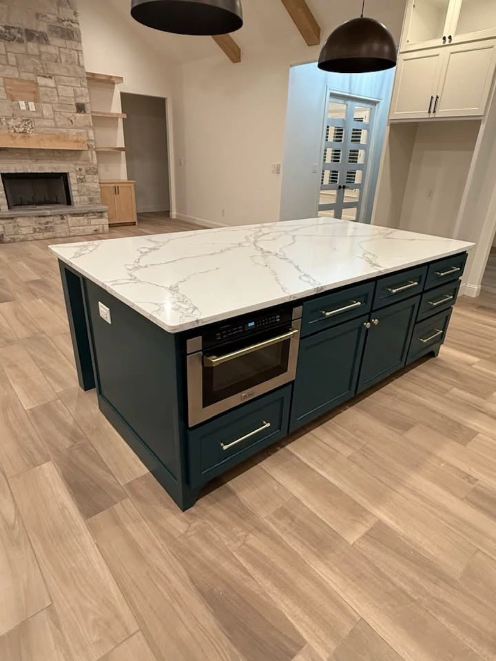 Custom countertop installation featuring a modern kitchen island, premium cabinetry, and open living space