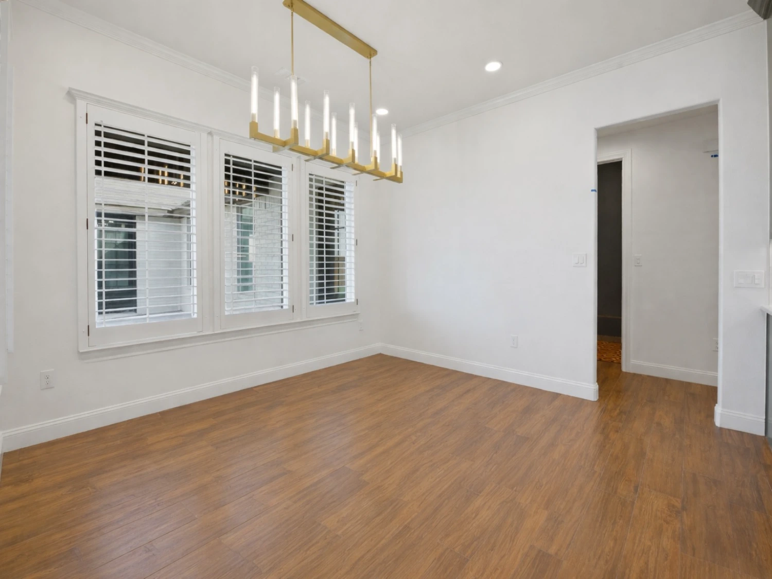 New home addition with a spacious open living area, modern lighting, and premium flooring built by Crystal Cabinets in Midland, TX.