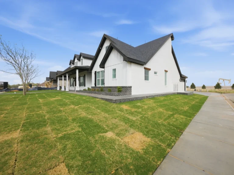 New custom home construction with modern farmhouse exterior design in Midland, TX