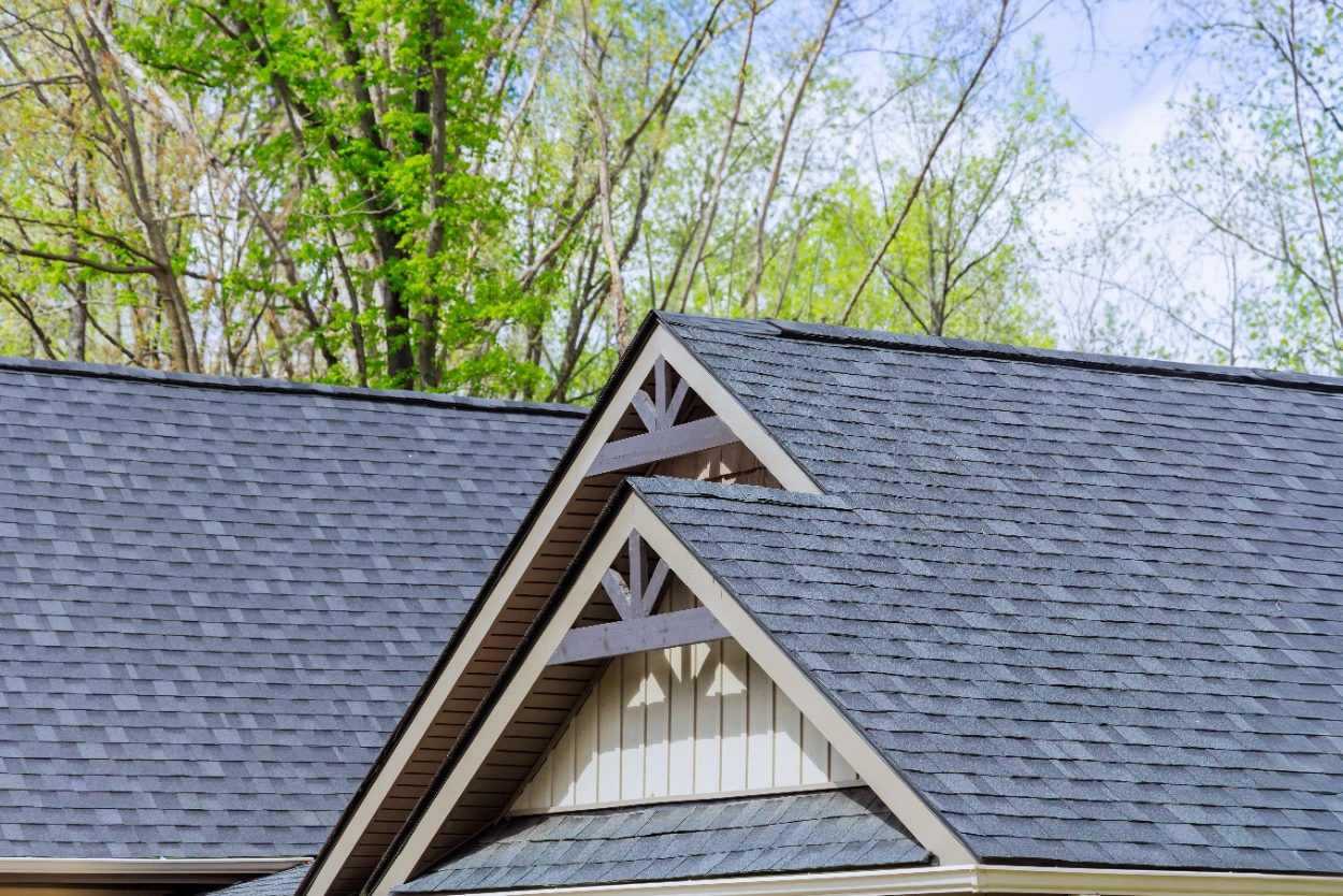 Grey architectural asphalt shingle roof on a gabled custom home with decorative trusses in Midland TX