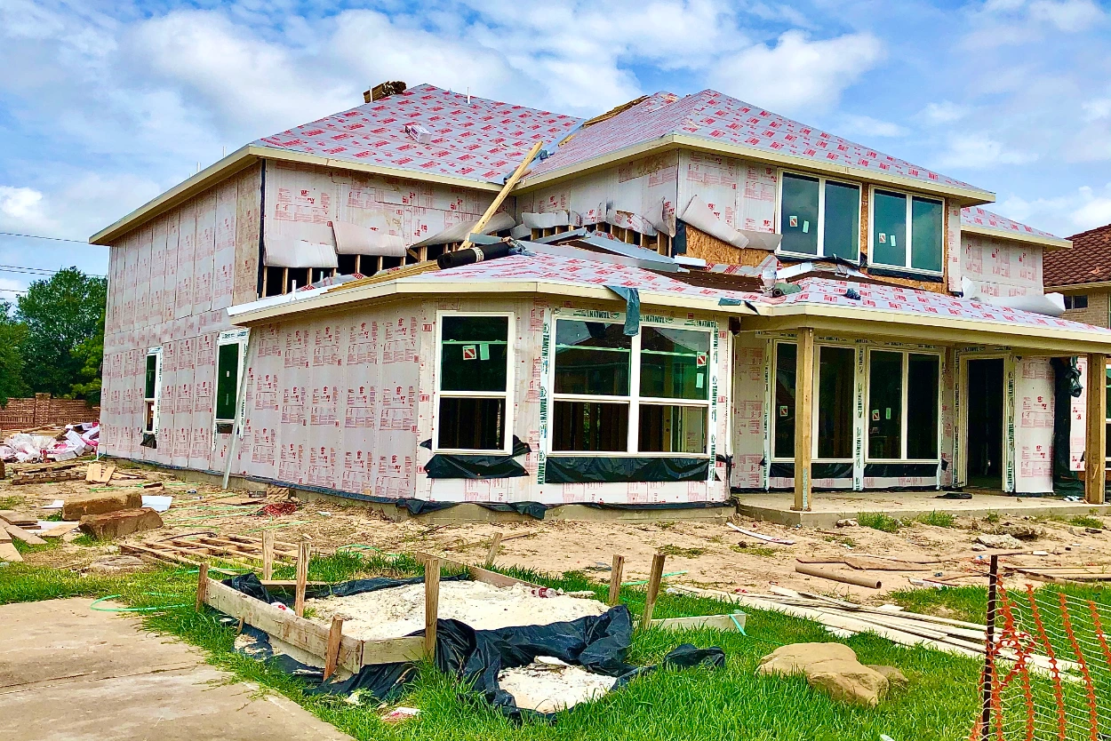 Custom home roofing construction featuring shingle roof installation and residential building craftsmanship