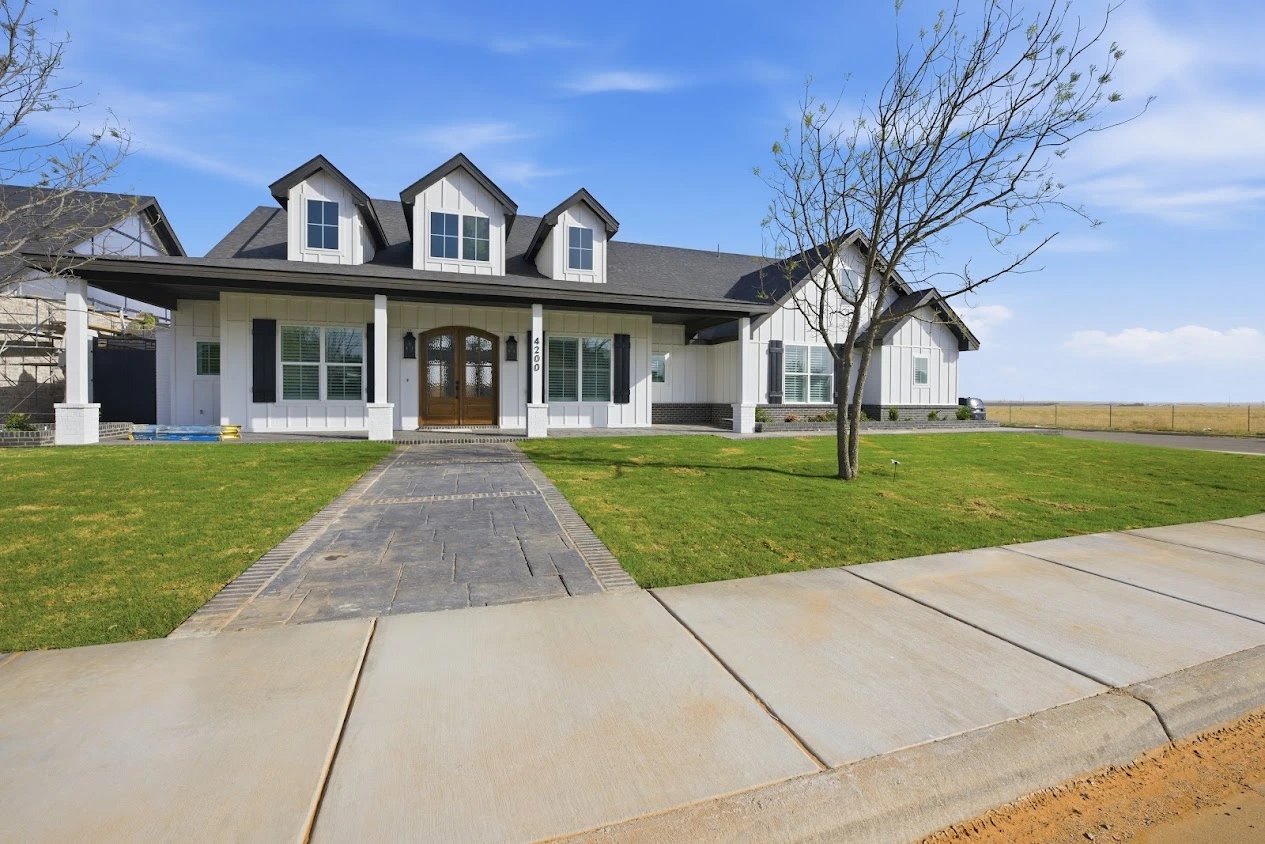 New custom home construction with modern farmhouse exterior design in Midland, TX