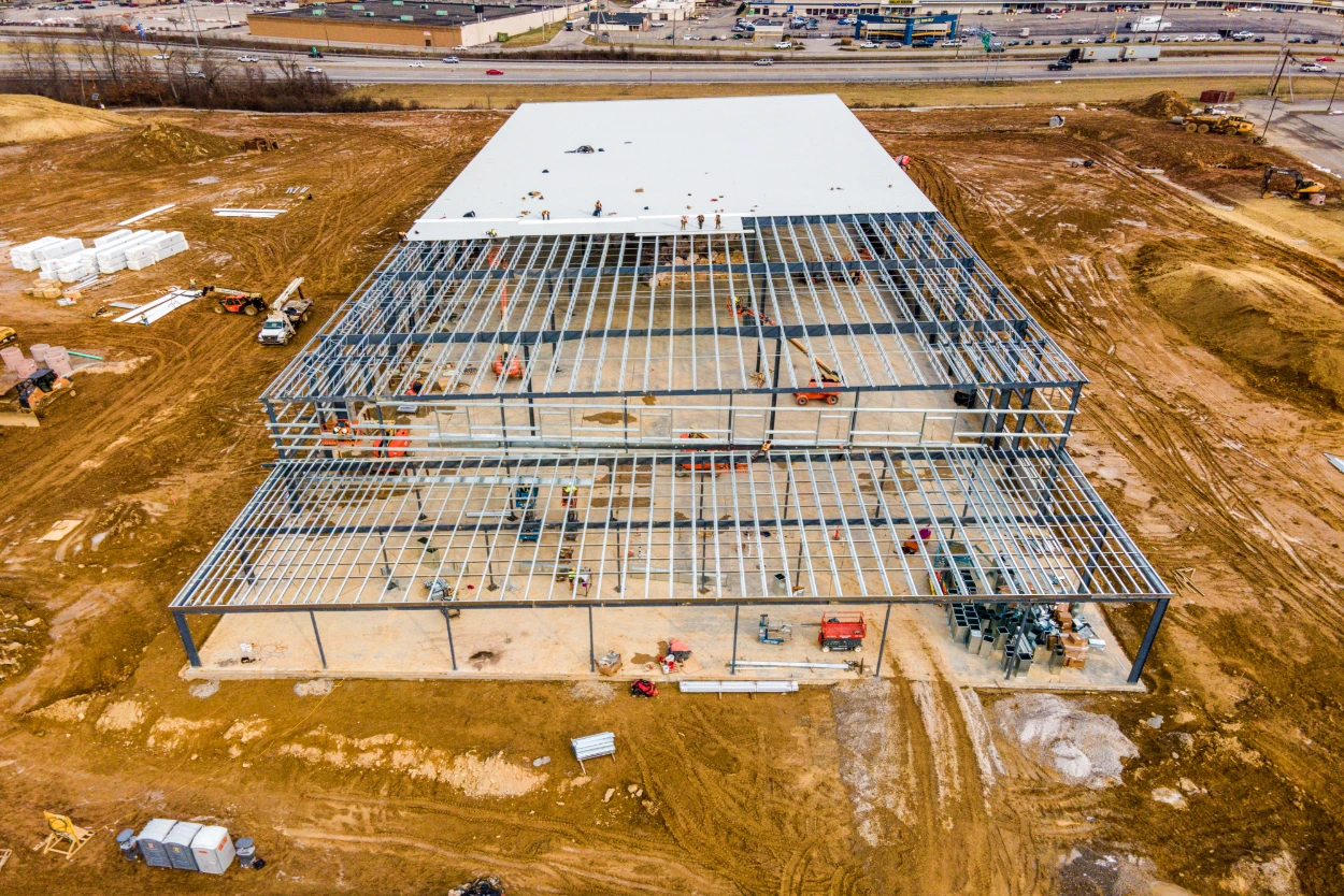 Steel frame commercial metal building under construction with roof decking in Midland TX