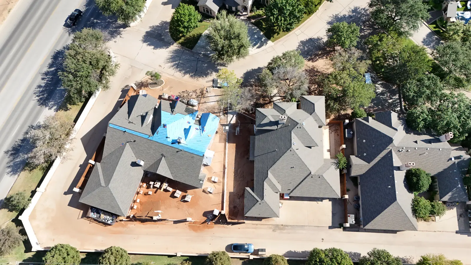 Mira Vista: Mira Vista Circle from above, with roof underlayment still showing on the new custom home.
