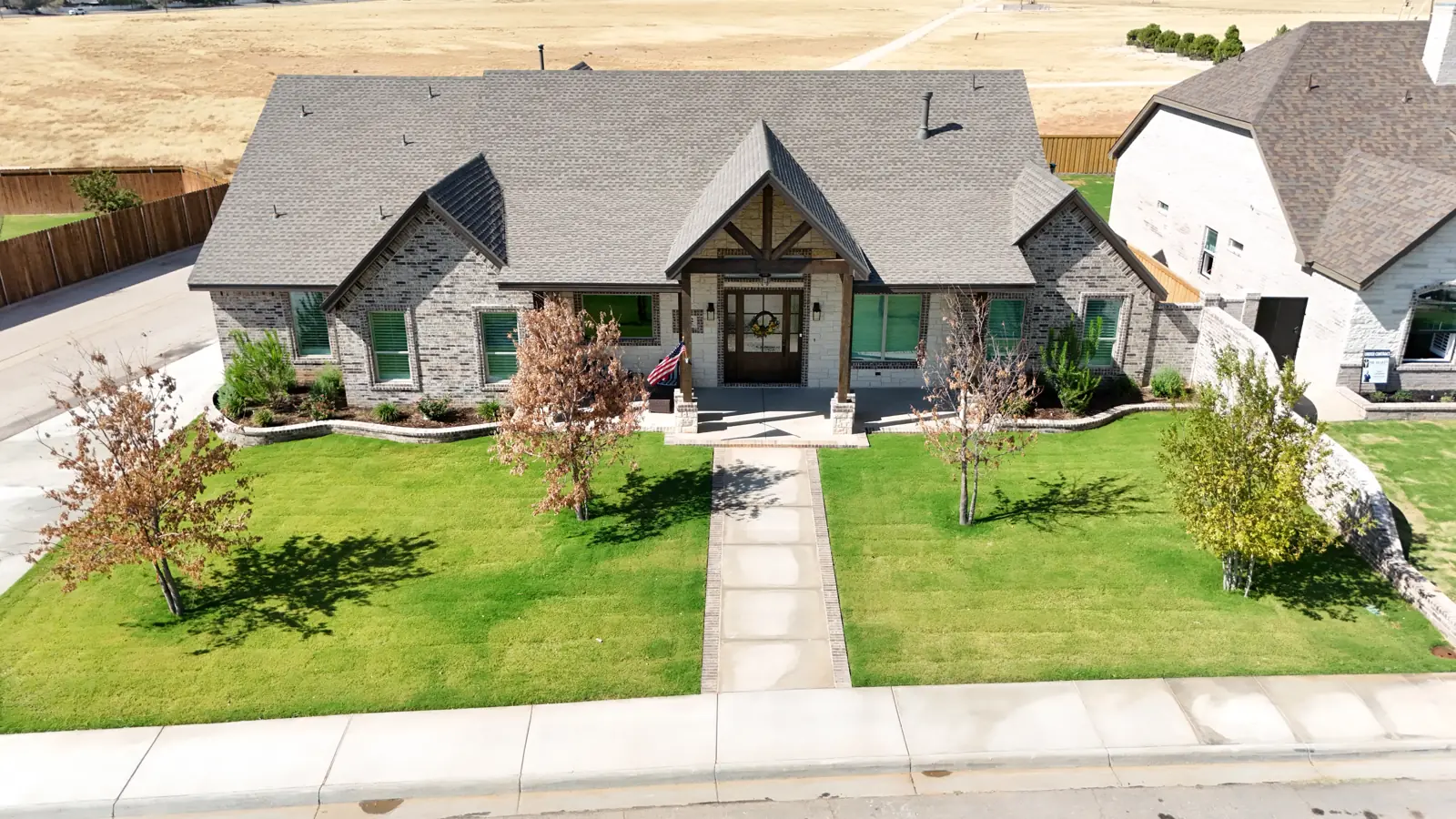 Mockingbird Heights: A brick and stone home with a timber gable framing the front entry.