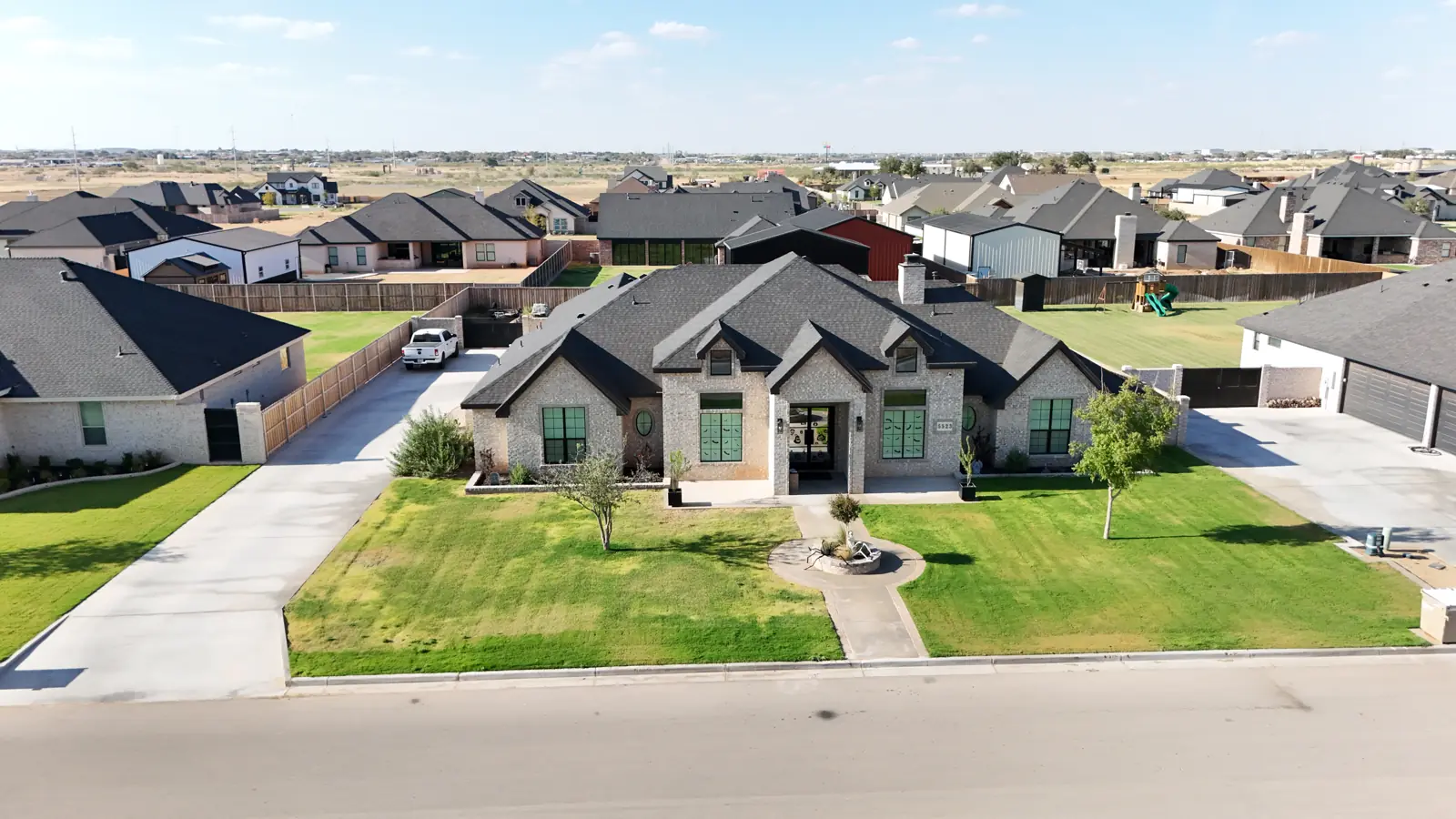 Saddleback Estates: A brick and stone custom home with arched windows and entry.