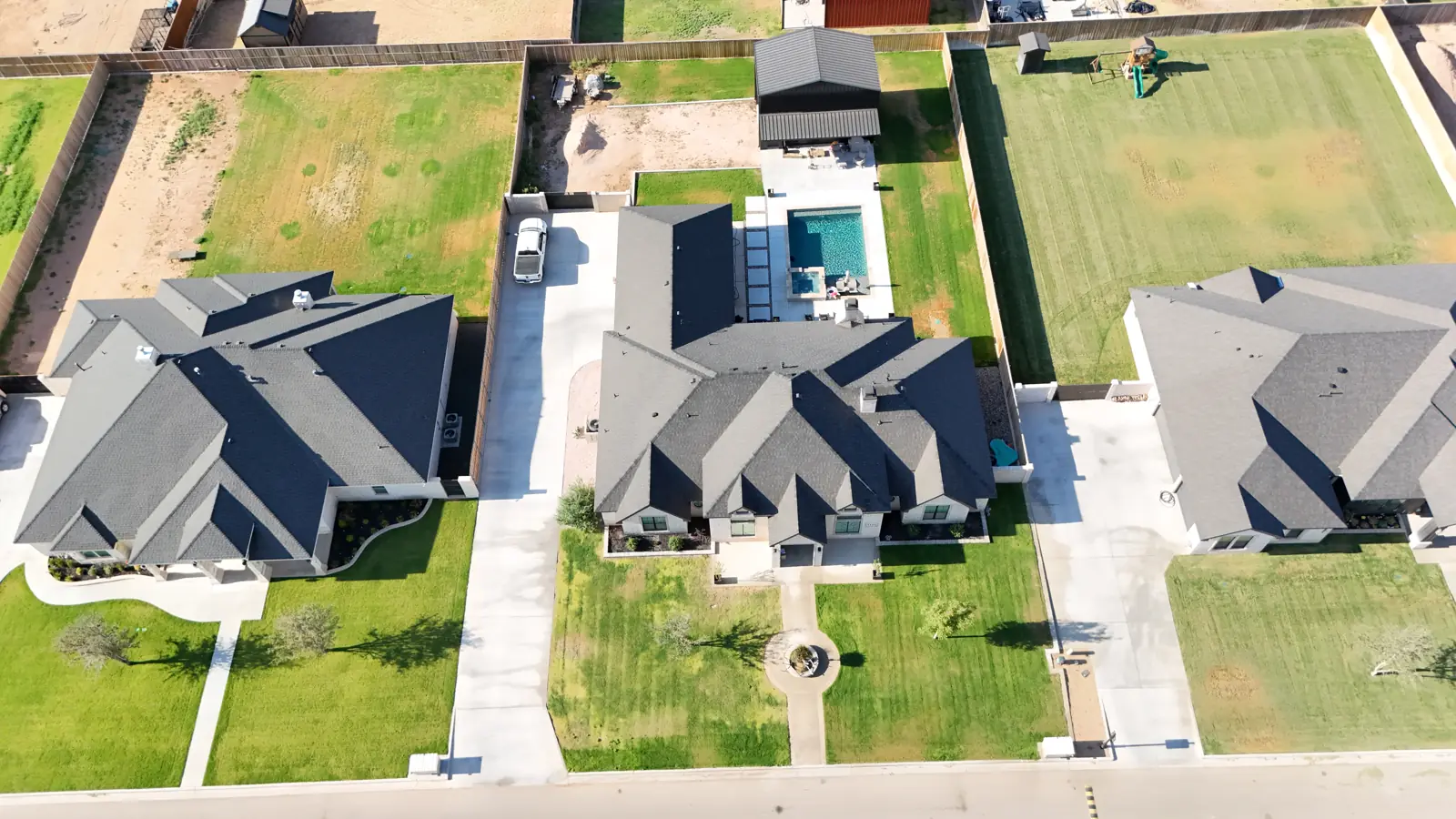 Saddleback Estates: A custom home with a backyard pool, seen from above.