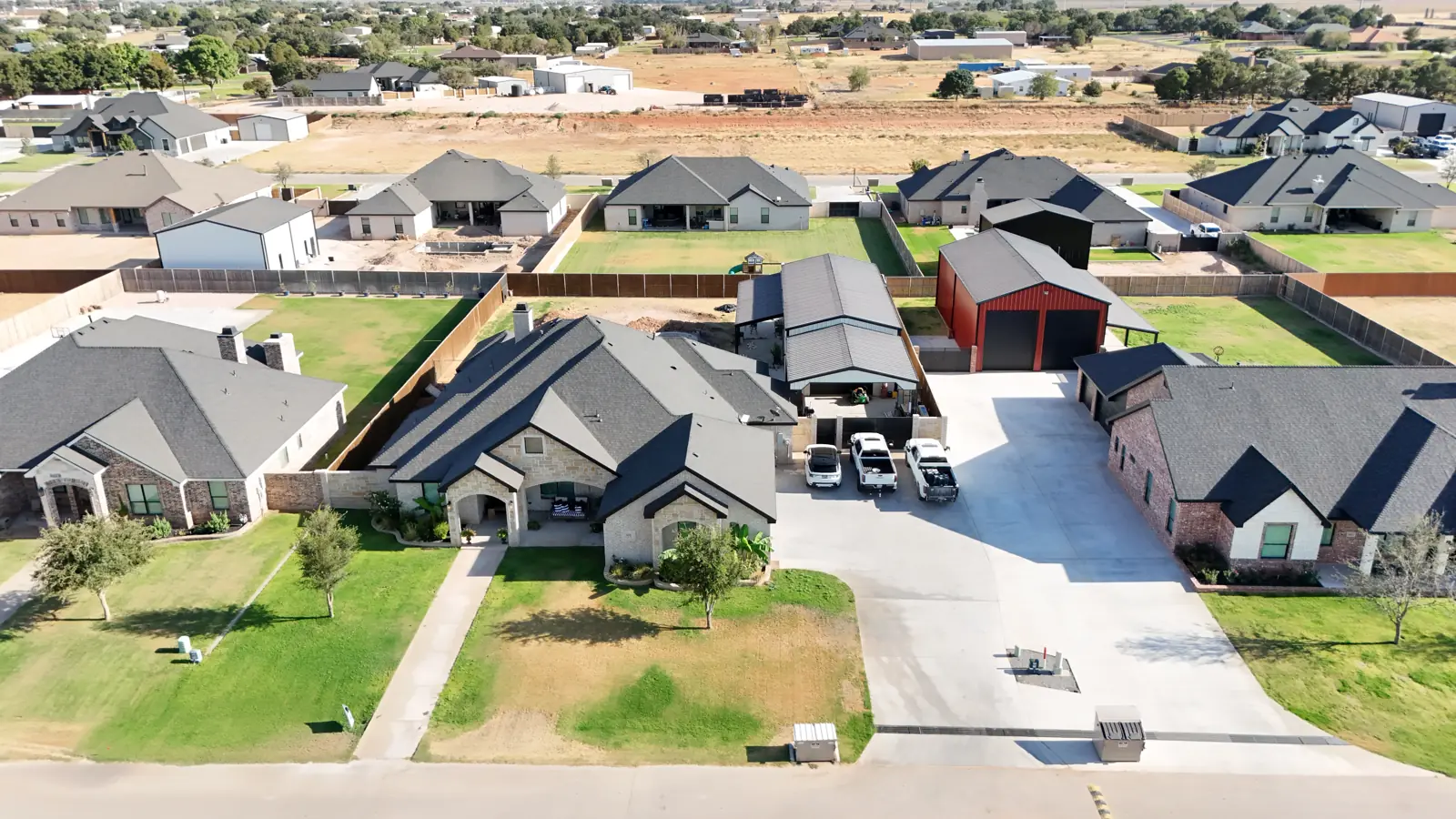 Saddleback Estates: Homes with metal shop buildings set behind them.